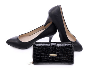 Women's shoes and a black wallet on a white background