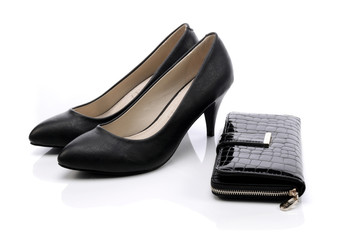 Women's shoes and a black wallet on a white background - obrazy, fototapety, plakaty