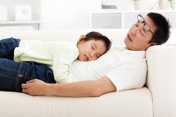 father and daughter sleeping on the sofa