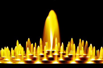 Yellow water fountain at night