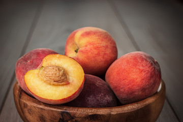 wooden bowl some fresh peaches on the table
