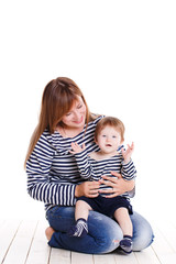 Young mother playing with her little daughter.