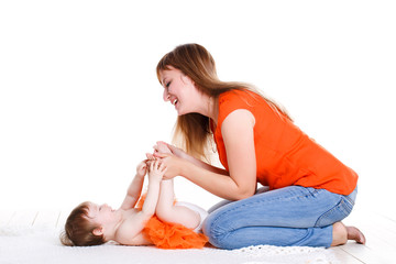 Young mother playing with her little daughter.