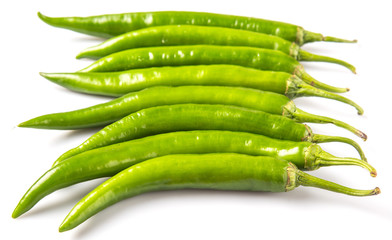 Green chili peppers over white background