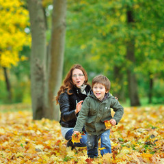 Fototapeta na wymiar Child runs away from mother while plaing in a park
