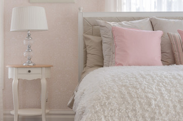 pink pillow on white luxury bed in bedroom