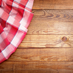 Wood texture, wooden table with red tablecloth tartan top view.