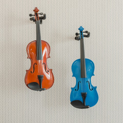 Fototapeta na wymiar blue and brown violins hang on wall