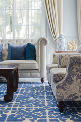 luxury living room with sofa on blue pattern carpet