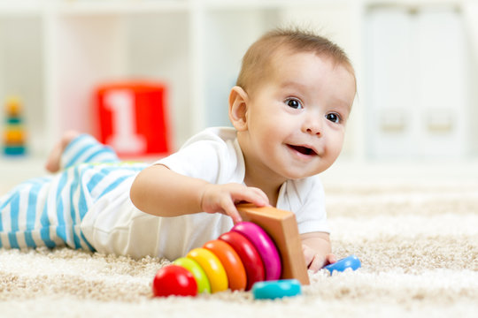 Child boy playing with toy at home