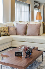 white sofa with pillows and wooden table in living room