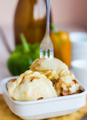 Fork dumplings with potatoes, fried onions and sour cream, Ukrai