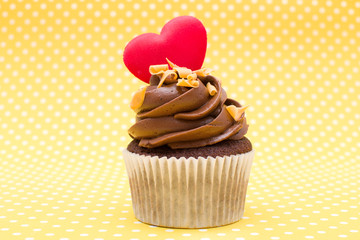 Valentine cupcake on yellow polka dot background