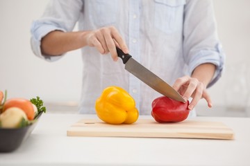 Pretty brunette slicing up peppers