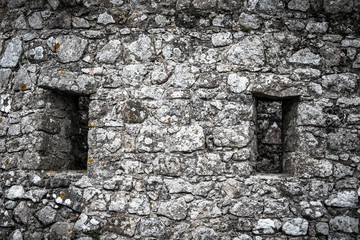 Windows in the old stone wall