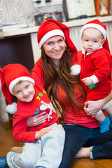 Mother with kids, baby Santas