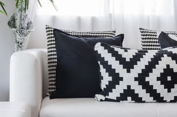 black and white pattern pillows on white sofa at home