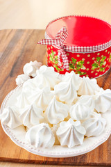 Many small white meringue with round christmas gift box.
