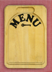 Menu sign with iron key and gingham tablecloth
