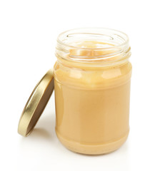 Creamy peanut butter in jar, isolated on white