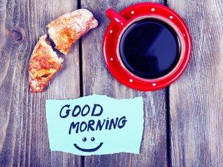 Composition of coffee, fresh croissant and paper card