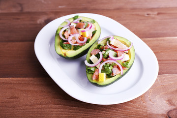 Tasty salad in avocado on plate table close-up