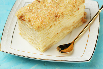 Napoleon cake on plate on table close-up