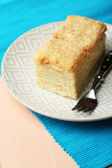 Napoleon cake on plate on table close-up