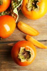 Ripe persimmons on wooden background