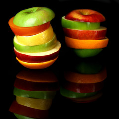 Fototapeta na wymiar Fresh sliced fruit isolated on black