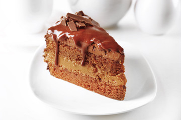 Delicious chocolate cake on plate on table on light background