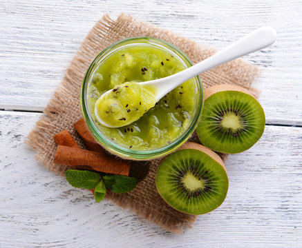 Delicious kiwi jam on table close-up