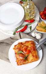 Portion of tasty lasagna on table