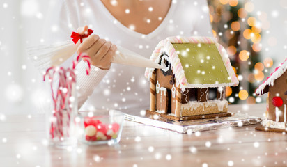 close up of woman making gingerbread houses