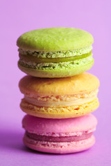 Assortment of gentle colorful macaroons on color background