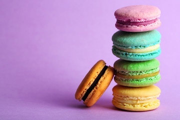 Assortment of gentle colorful macaroons on color background