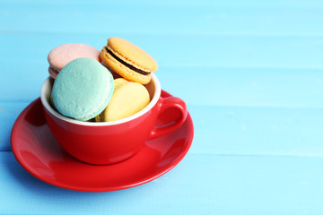 Assortment of gentle colorful macaroons in colorful mug