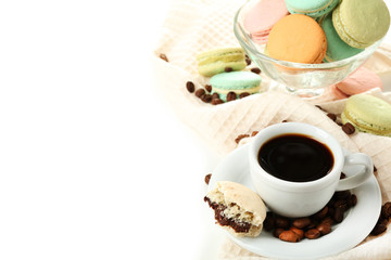 Gentle colorful macaroons in glass bowl and black coffee in mug