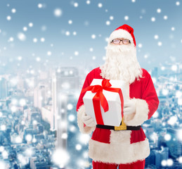man in costume of santa claus with gift box