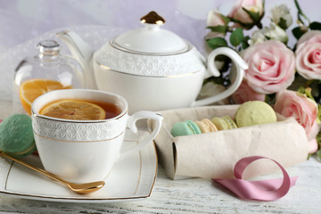 Obraz na płótnie Canvas Colorful macaroons with cup of tea