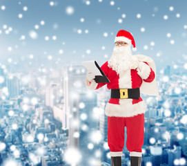 man in costume of santa claus with notepad and bag