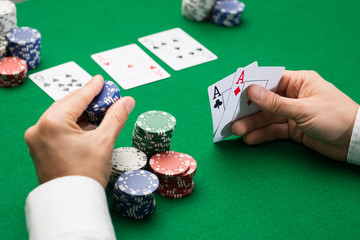 poker player with cards and chips at casino