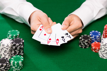 poker player with cards and chips at casino