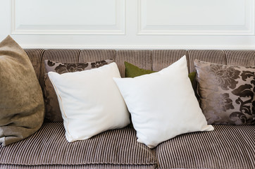 white pillows on  brown sofa