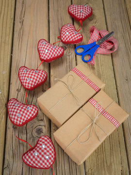 string and brown paper parcels with scissors, ribbon  and hearts