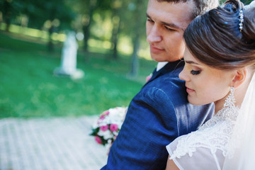 Beautiful wedding couple posing in park