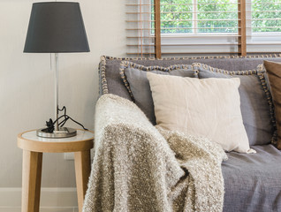 brown blanket on sofa with lamp in living room