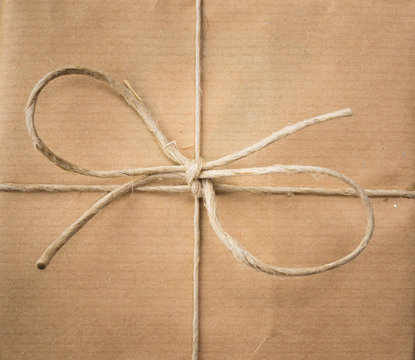 string bow against brown paper