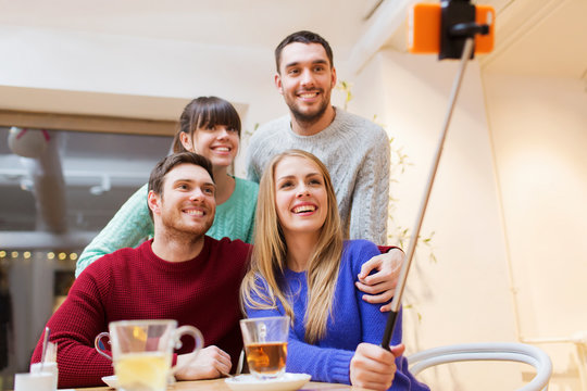 group of friends taking selfie with smartphone
