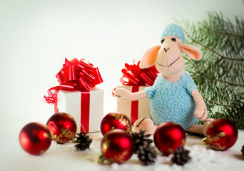 toy lamb with Christmas balls and fir paws gifts